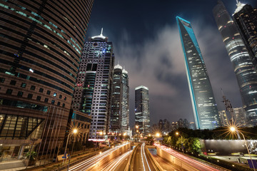 Fototapeta na wymiar Light trails on the modern building background in Shanghai, China