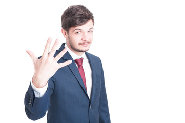 Marketing man showing number five with one hand