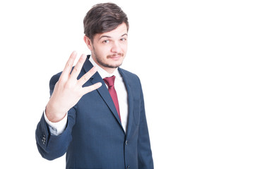 Sales man showing number four with one hand