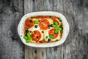 Vegetables baked with feta. healthy eating, vegetarian dish. Greek food of mediterranean cuisine.