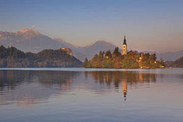 Fototapeta na wymiar Sunset over the church and lake in Bled, Slovenia