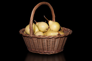 Wicker Basket with pears on pure black background.