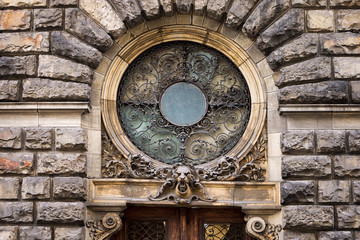 Detail of the facade, retro wrought iron decoration above the entrance.