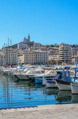 Yachts in the port of Marseilles on the background of the church of Notre Dame de la Garde