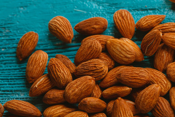 handful of almonds on a blue wooden background