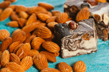 candy paste and almonds on blue wooden background