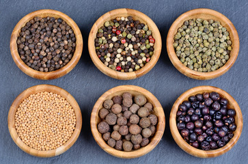 Different spices in a bowls on slate