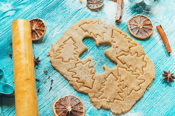 Gingerbread dough with molds for baking cinnamon on blue wooden table