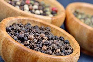 Variation peppercorns in a bamboo bowls