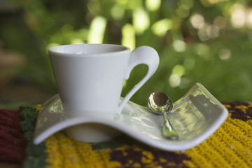 beauty decoration af a cup of coffee on the table with spoon. Blurred background