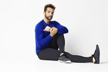 Stretching sports guy in studio, portrait