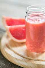 Glass jar of grapefruit smoothie