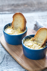 Bowls of onion soup on the wooden board