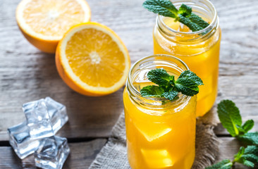 Glass jars of orange juice