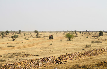 Fototapeta na wymiar Traktor in a desert