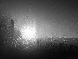 Obraz premium Raindrops on glass surface. Natural Pattern of rain drops window background in black and white.
