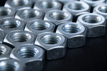 Close up hex nuts put row abstract style