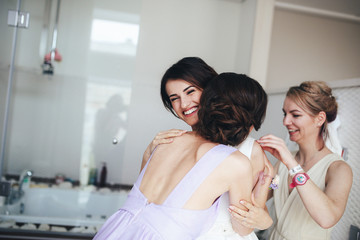 The bridesmaid embracing a charming bride