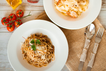 Spaghetti with tomato paste, hot Chili peppers and olive oil. On rustic background. Top view