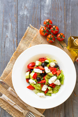 Greek salad with fresh vegetables, feta cheese and black olives. Top view