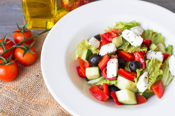 Greek salad with fresh vegetables, feta cheese and black olives. Top view
