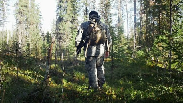 Man hunter outdoor in forest hunting alone