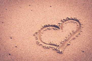 Copy space of heart shape on sand beach. Travel concept.