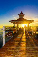 gazebo bridge sea at sunset