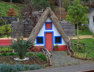 Fototapeta na wymiar Traditional house in Santana on background, Madeira island, Portugal 