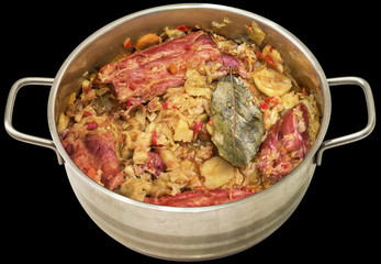 Cabbage with Smoked Pork Ribs Cooked in Stainless Steel Saucepot Isolated on Black Background