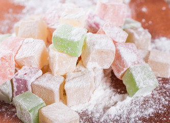 Close up shot of pile of turkish delight or lokum of red, green, orange and yellow colors.