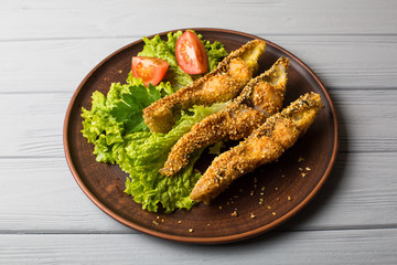 Tasty baked fish on plate table close-up