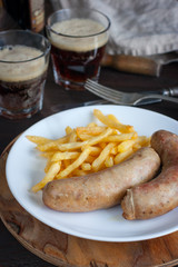 Homemade sausages with potatoes, selective focus
