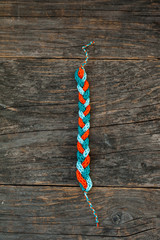 Handmade knitted bracelet on a wooden background © sgabby2001