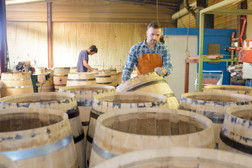 Workers in room full of new barrels © auremar