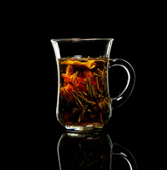 cup with Flower Chinese tea on a black background