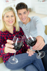 Couple drinking red wine on the sofa