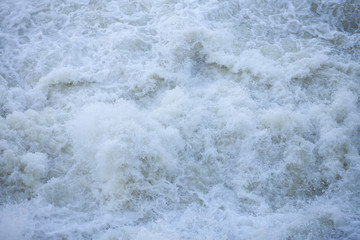 Water flowing from the open sluice gates of dam.