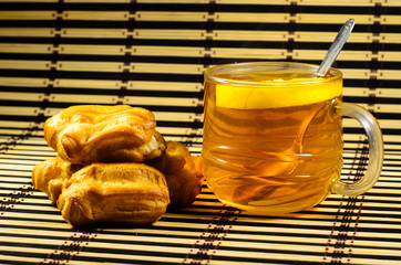 Eclairs and tea on a bamboo mat