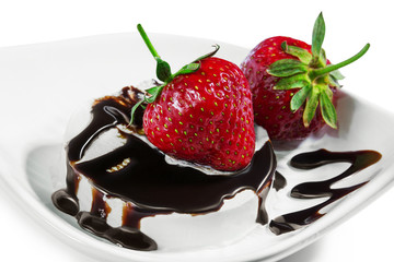  strawberries on an ice cream drizzled by chocolate on a white p