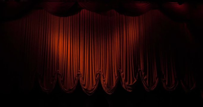 A red curtain stage opening and fading to black