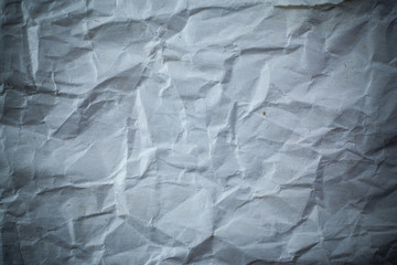 Recycled crumpled gray paper background dark edged.