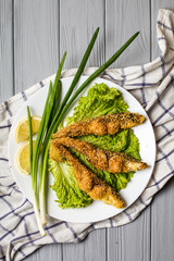 Tasty baked fish on plate table close-up