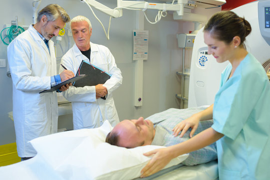 Patient having mri scan being reassured by nurse