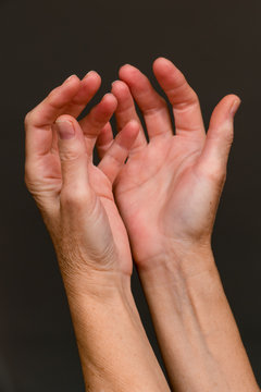 Begging hands, close-up / Old woman begging hands on dark background