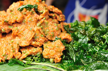 Thai fried fish-paste balls and fried kaffir lime leaf.