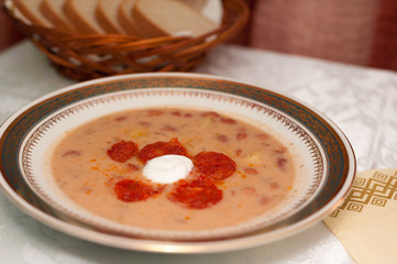 Bean soup with cream sausage on a plate