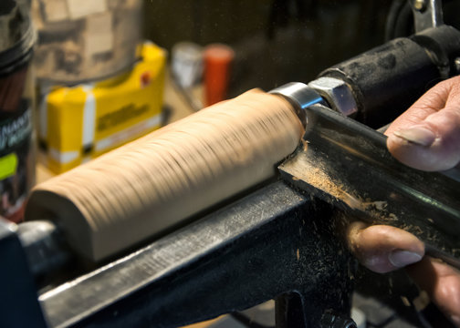  Worker Turning Wood On A Lathe 