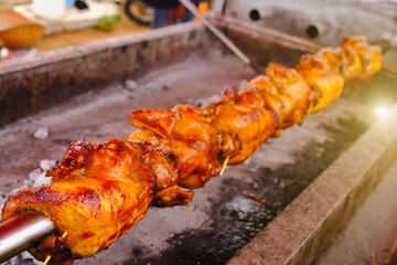 Free range chicken for roasting traditional at street food vendor market , thai local food. Selective focus and  with lighting flare effect.