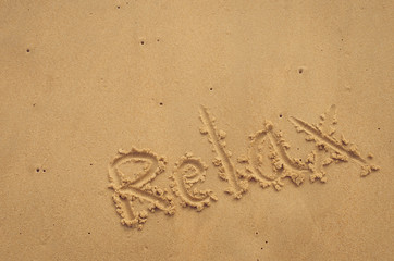 Copy space of Relax words on sand beach texture background.